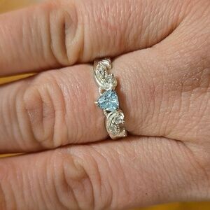 Light blue triangle stone with swirls and diamond accents